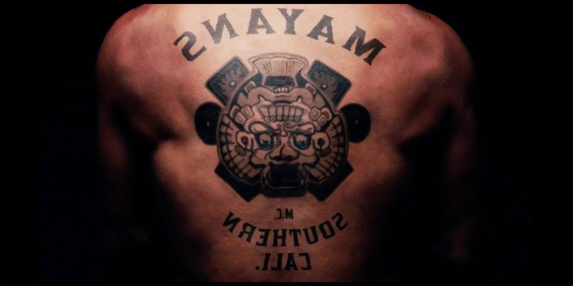 A close-up of a back tattoo of the Mayans M.C. logo Image