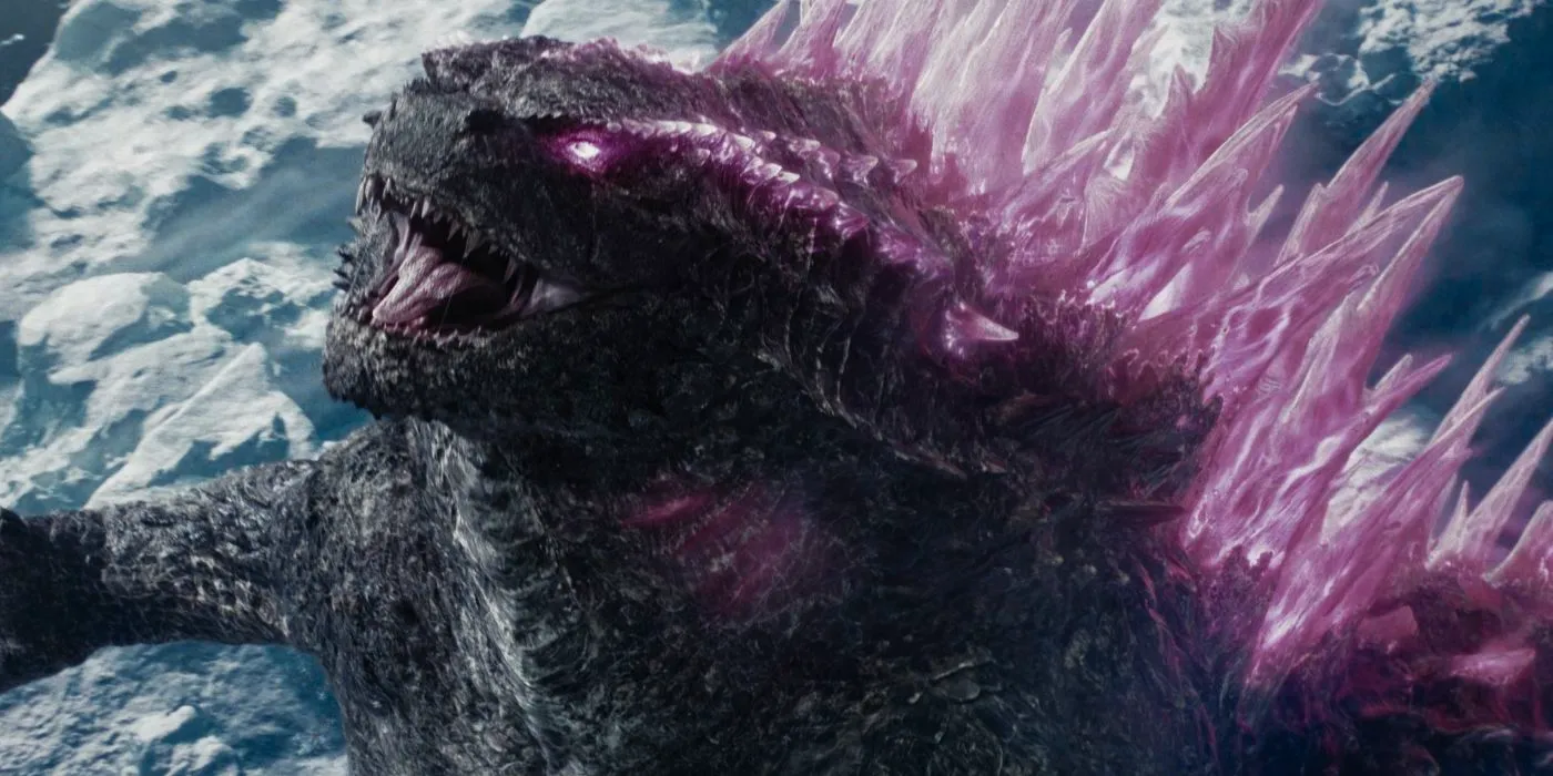 A close-up of Godzilla in Godzilla x Kong: The New Empire with glowing pink fins and eyes. Image