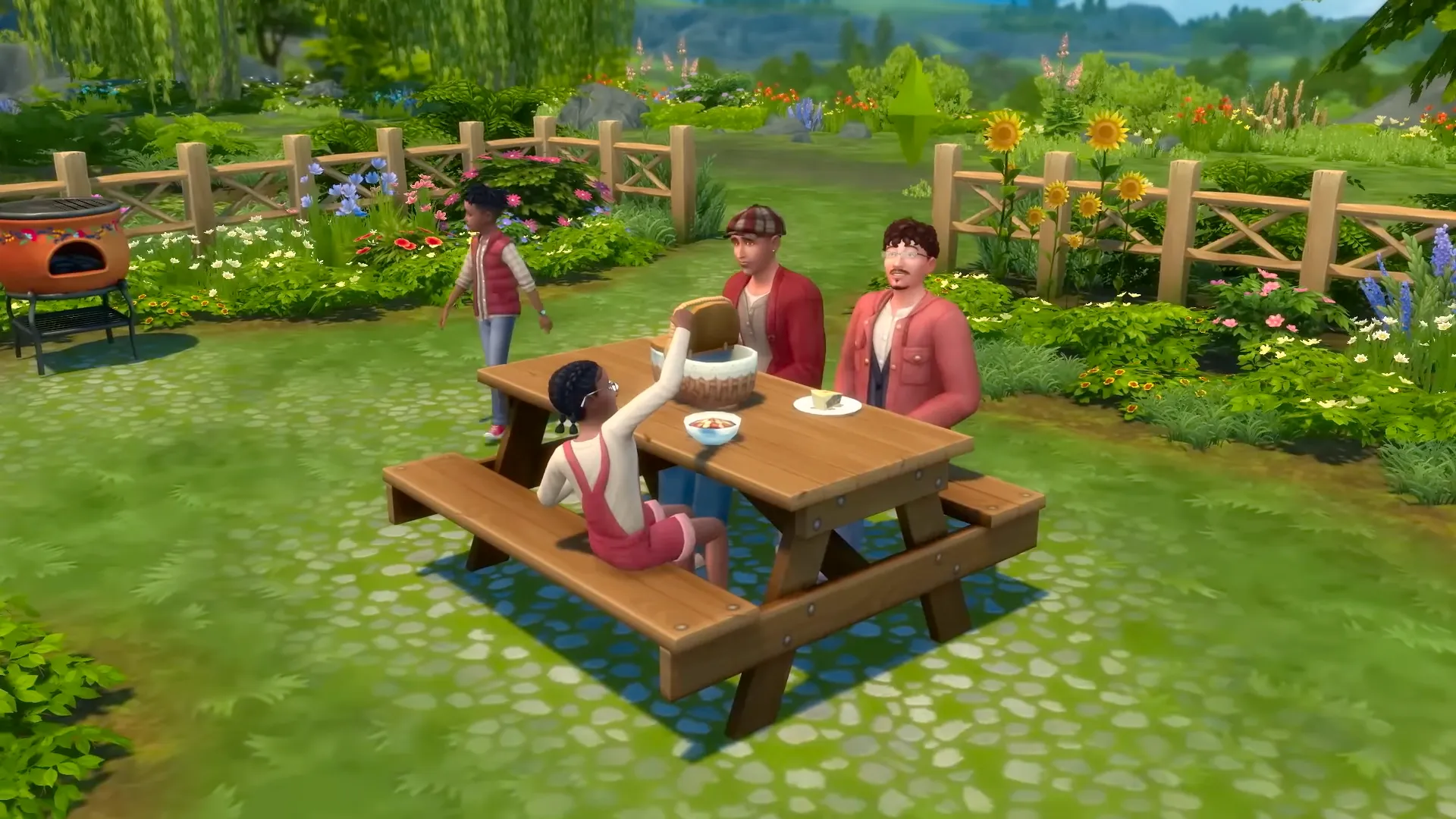 A family of Sims have a picnic in a beautiful field surrounded by sunflowers and other plants. Image