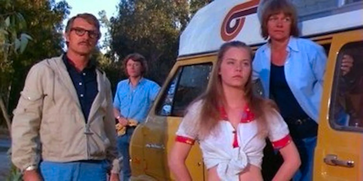 A family stands next to a van and looks out before them.  Image