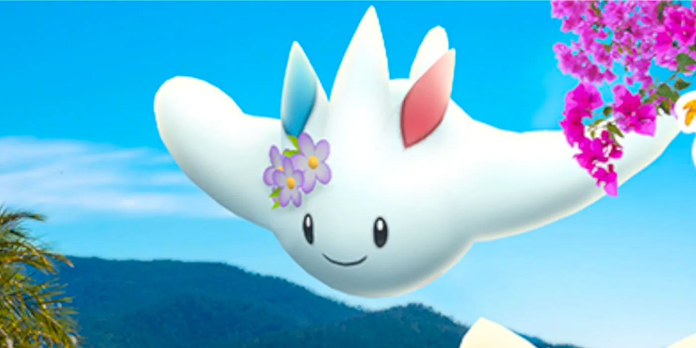 A Flower-Crowned Togekiss from Pokémon GO flies with a smile on its face. Image