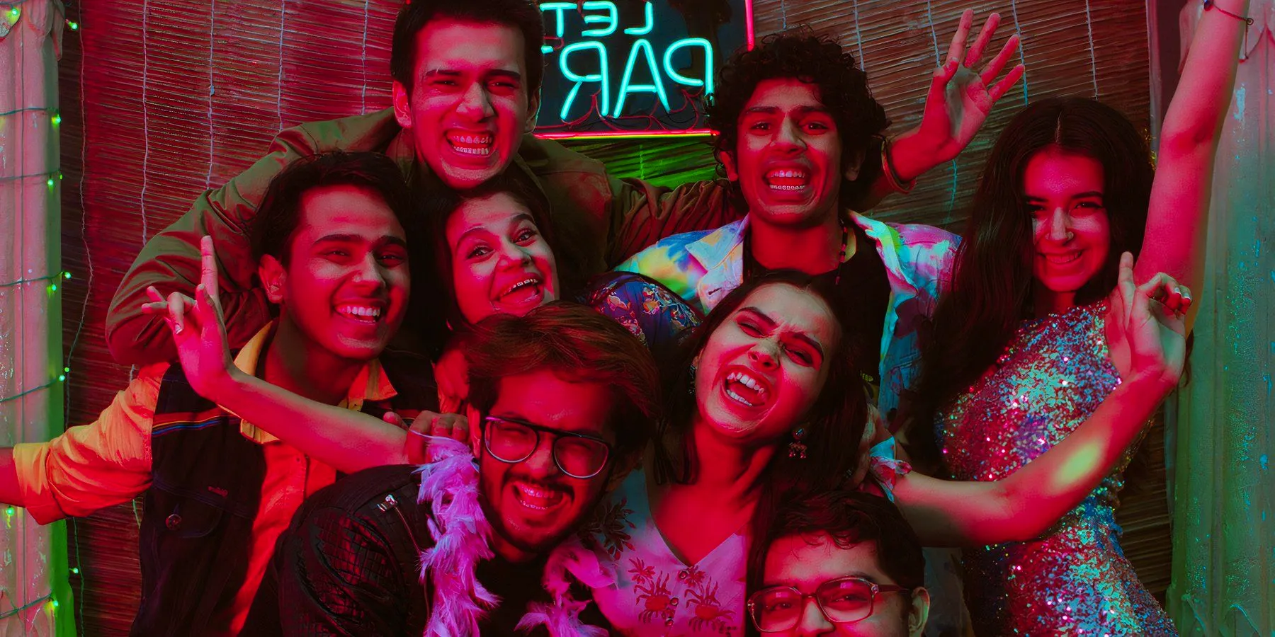 A group of students in front of a neon party sign in the Hindi series Crash Course Image