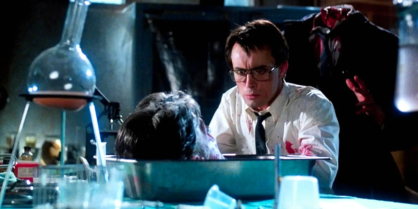 A headless body behind a scientist talking to a head in Re-Animator Image