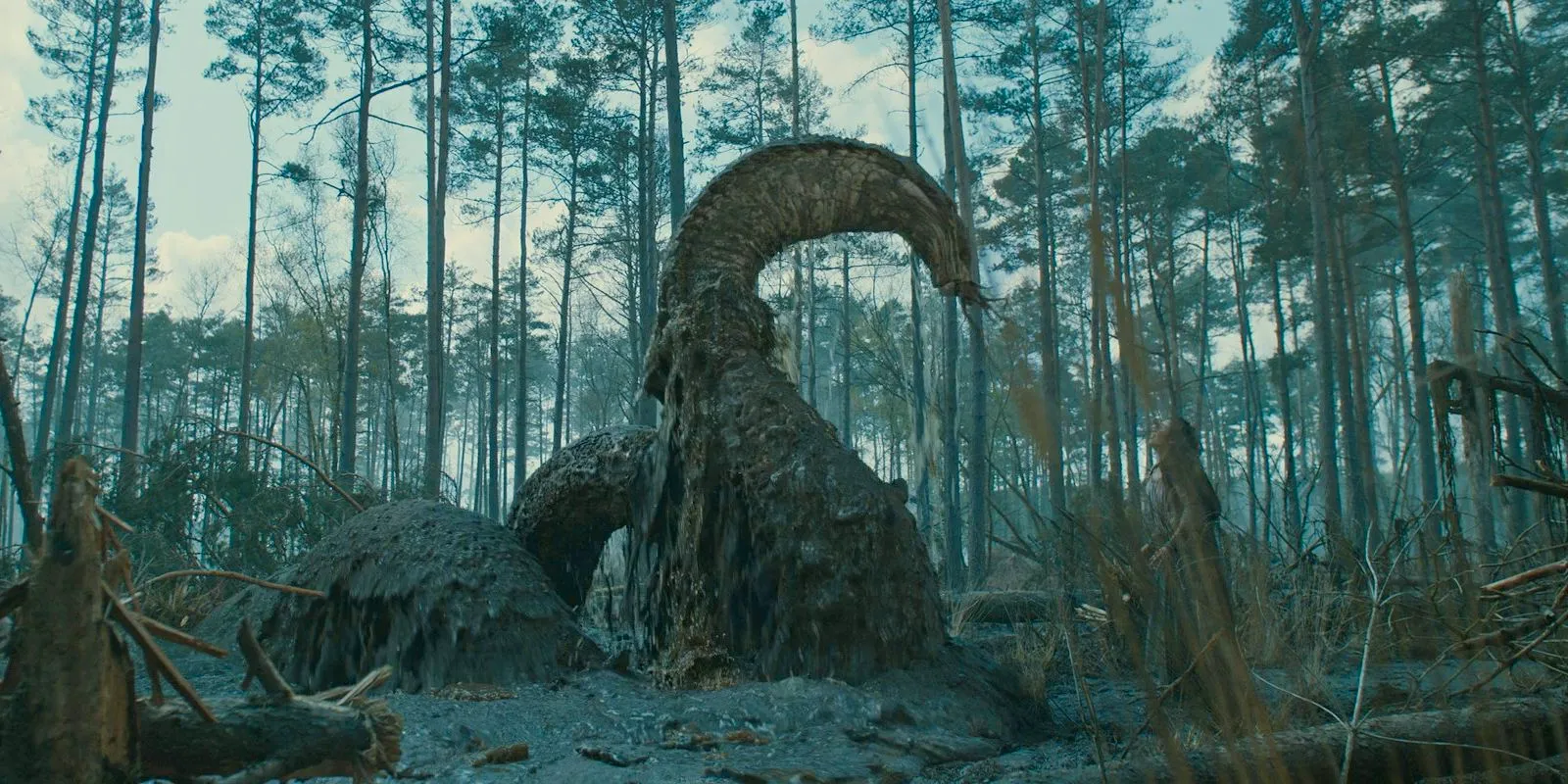 A monster emerges from the swamp and attempts to attack Estrid in The Lord of the Rings: The Rings of Power Season 2 Episode 4 Image