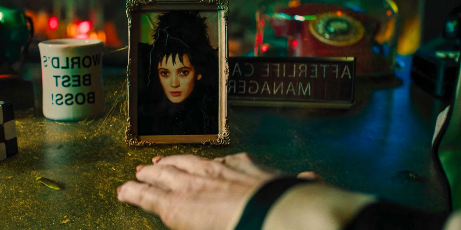 A picture frame with Lydia's picture as a young girl on Beetlejuice's desk in Beetlejuice 2 Image