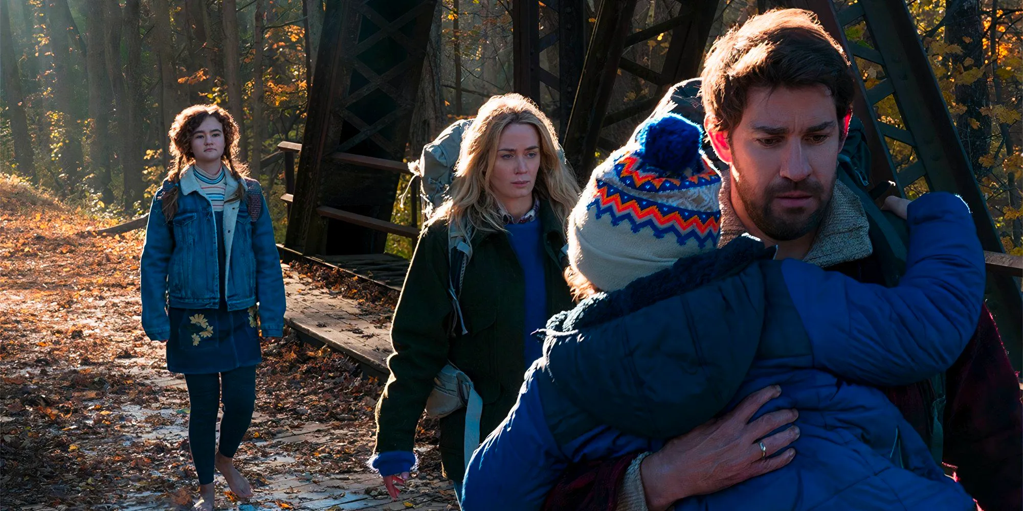 A Quiet Place cast walk across a bridge in the daytime Image