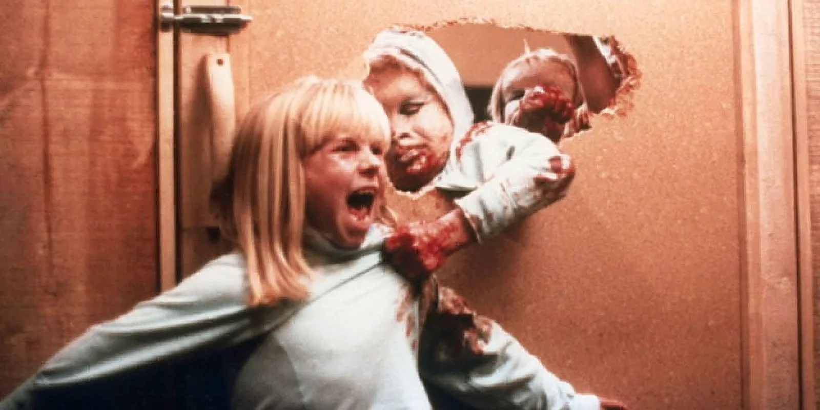 A screaming girl being pulled by a monster in David Cronenberg's The Brood Image