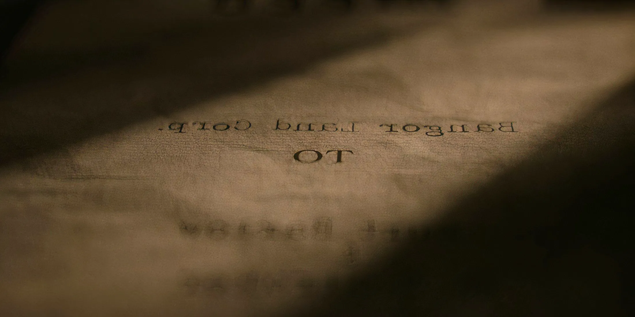 A screenshot from the Salem's Lot 2024 opening credits of a paper that reads Bangor Land Corp Image