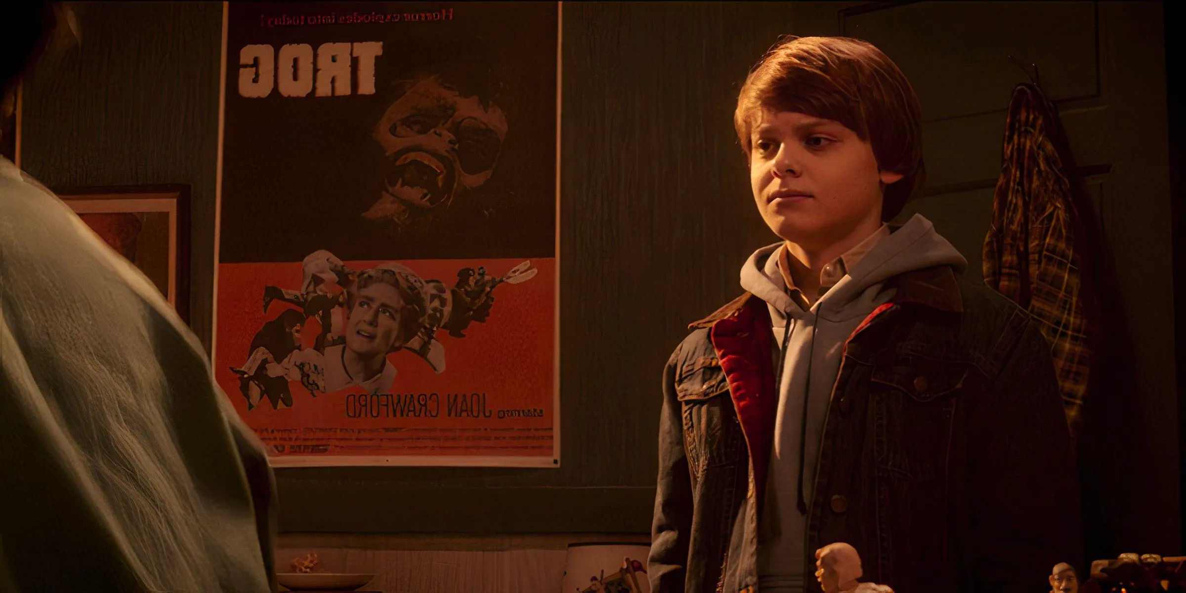 A shot of a boy standing in front of a Trog poster in Salem's Lot 2024 Image