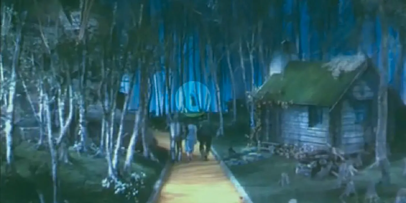 A shot of the Yellow Brick Road in The Wizard of Oz with a circle focusing on what is supposed to be a body hanging in the background of the trees Image