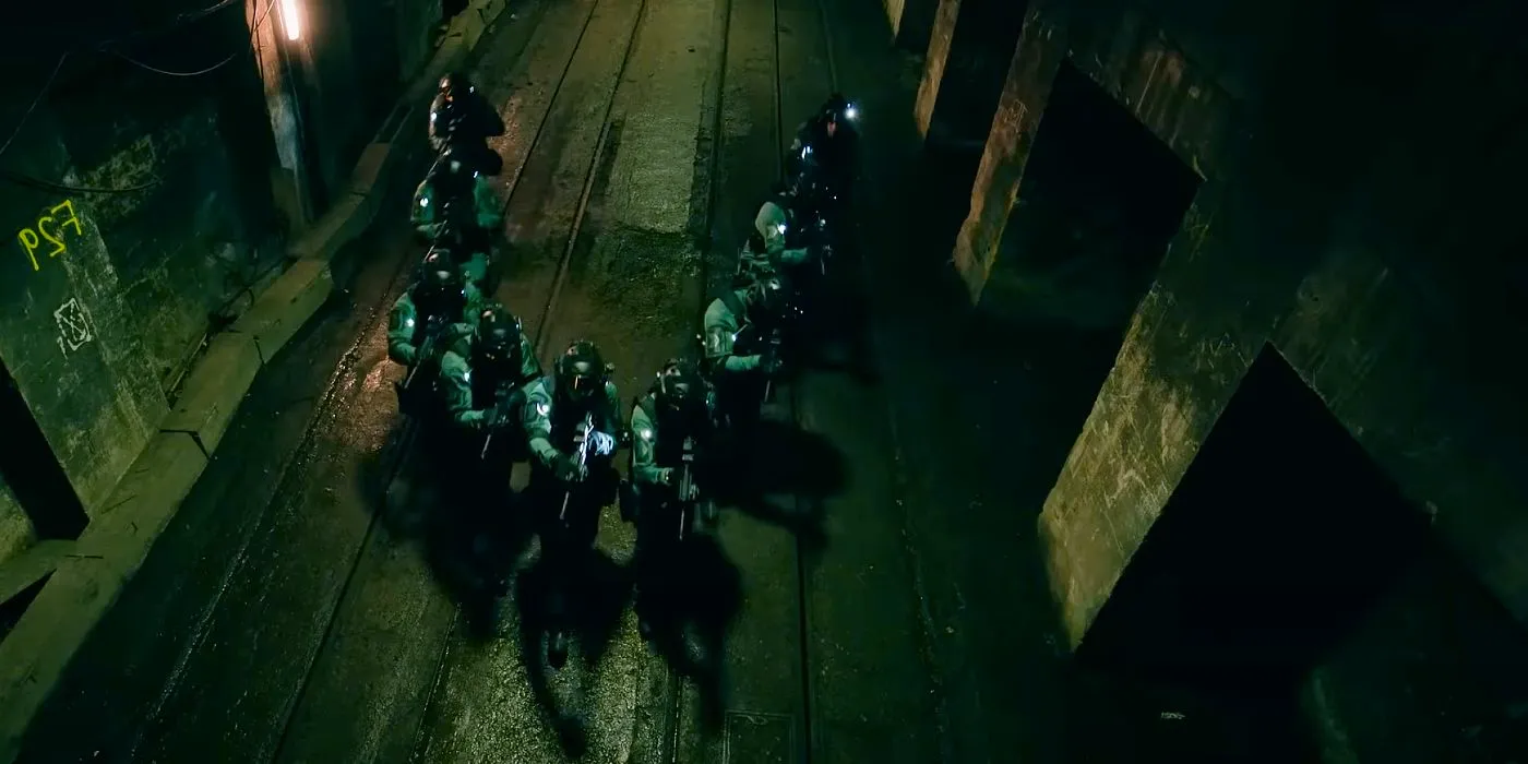 A tactical team with guns advances in a V formation down a tunnel in Slow Horses season 3 Image