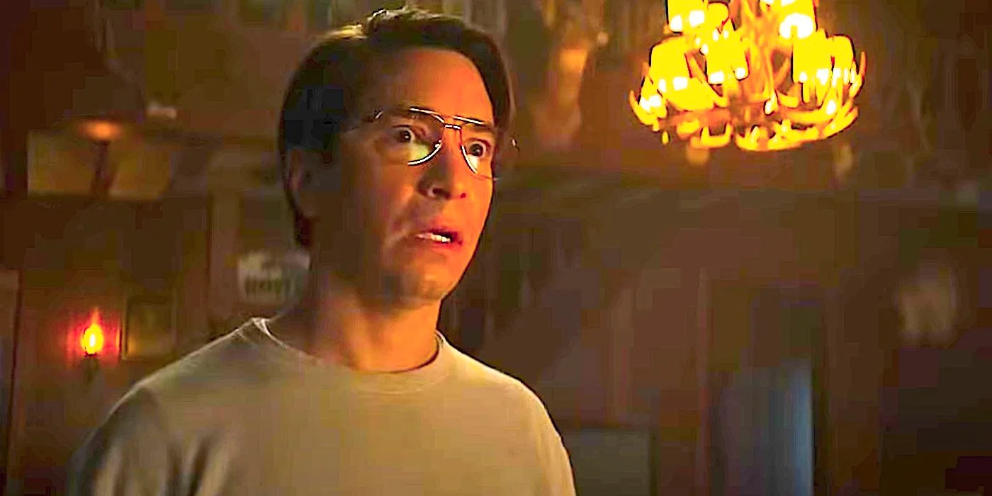 A terrified Mr. Bratt stares at something in Goosebumps 2023 season 1 with a chandelier in the background Image