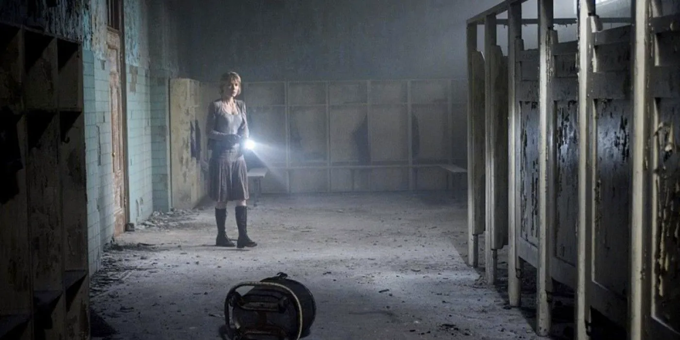 A woman explores an abandoned bathroom in Silent Hill Image