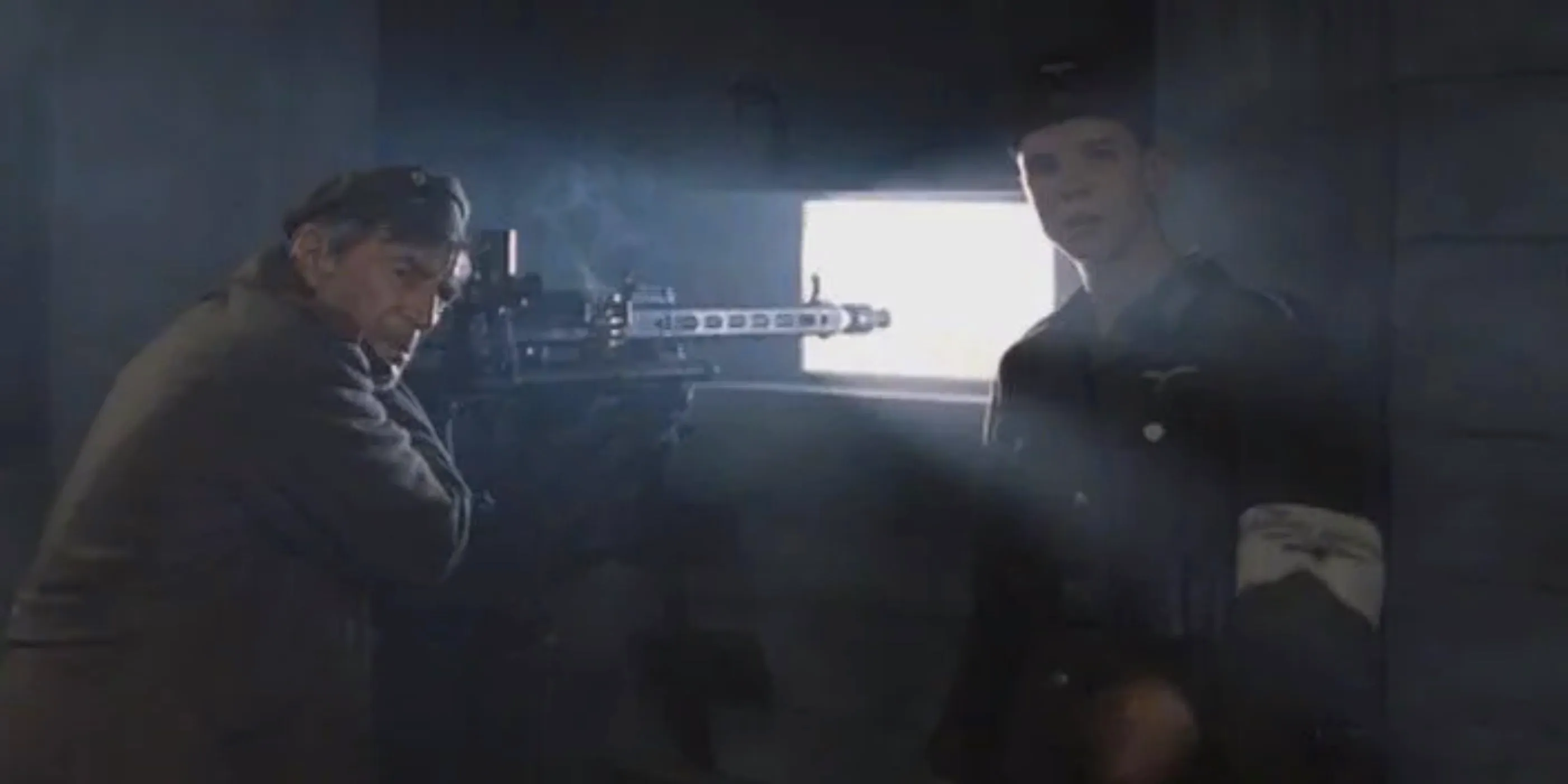 A younger and an older soldier stood by a Gatling gun in the Bunker Image