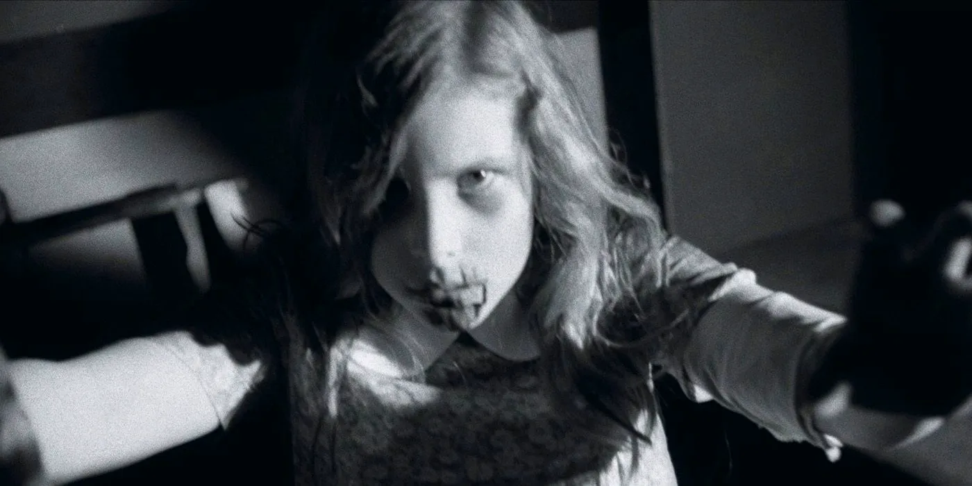 A zombie girl lunges toward the camera in Night of the Living Dead Image