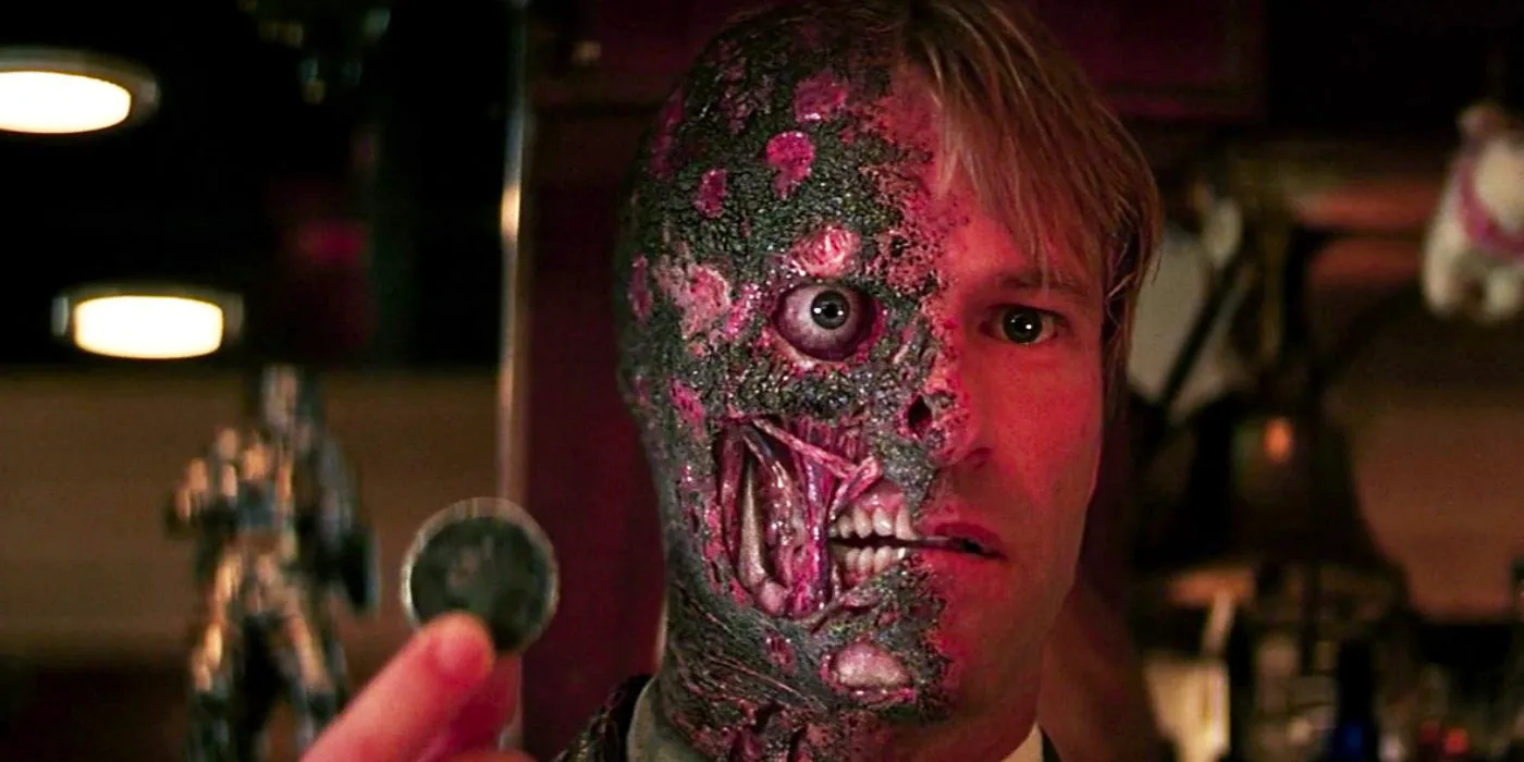 Aaron Eckhart as Harvey Dent holding a coin in The Dark Knight Image