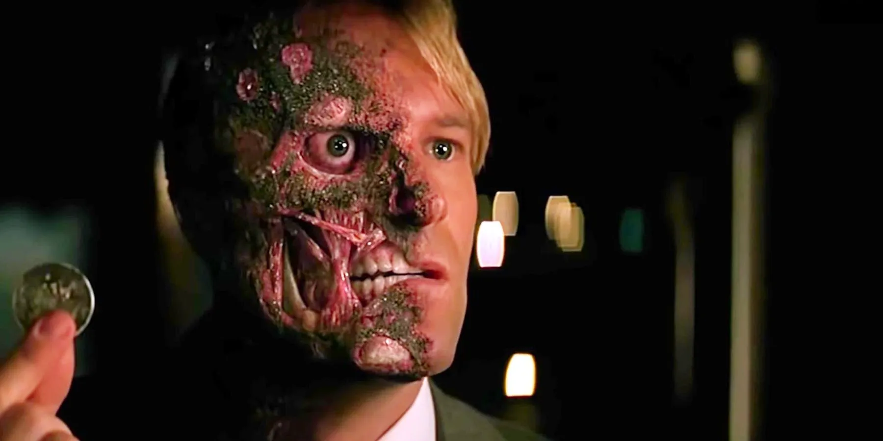 Aaron Eckhart as Harvey Dent in The Dark Knight (2008) about to flip a coin Image