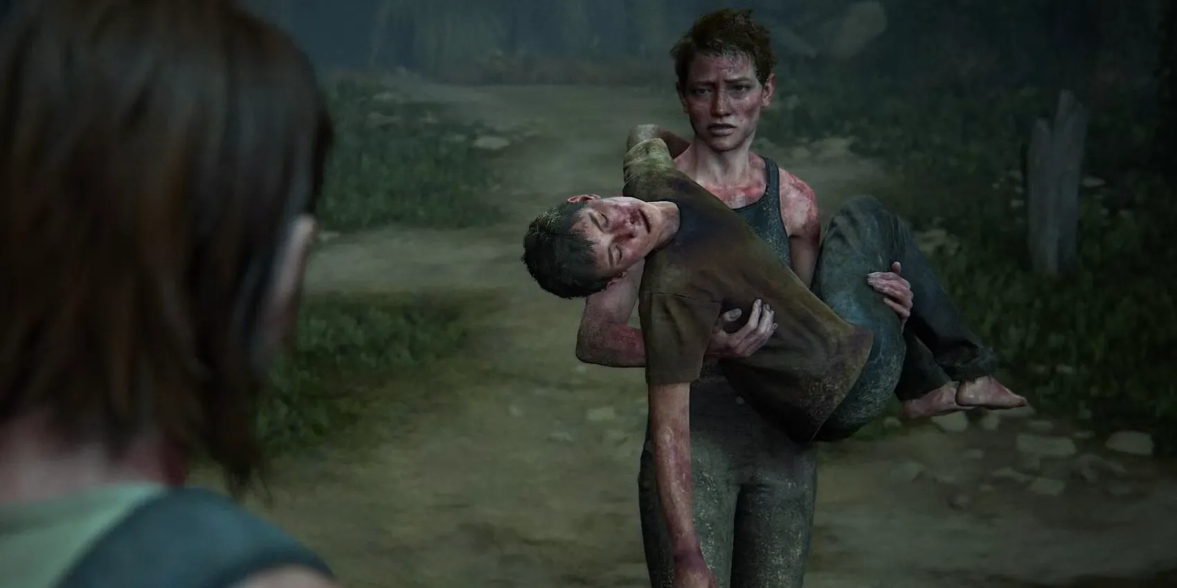 Abby carries Lev on the beach in The Last of Us Part II Image