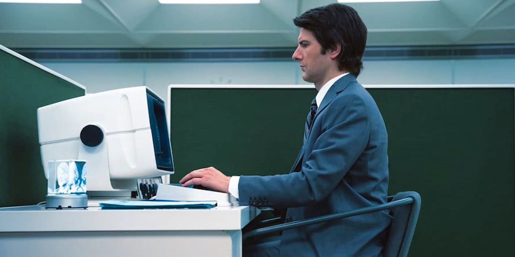 Adam Scott as Mark sits at a computer in Severance Image