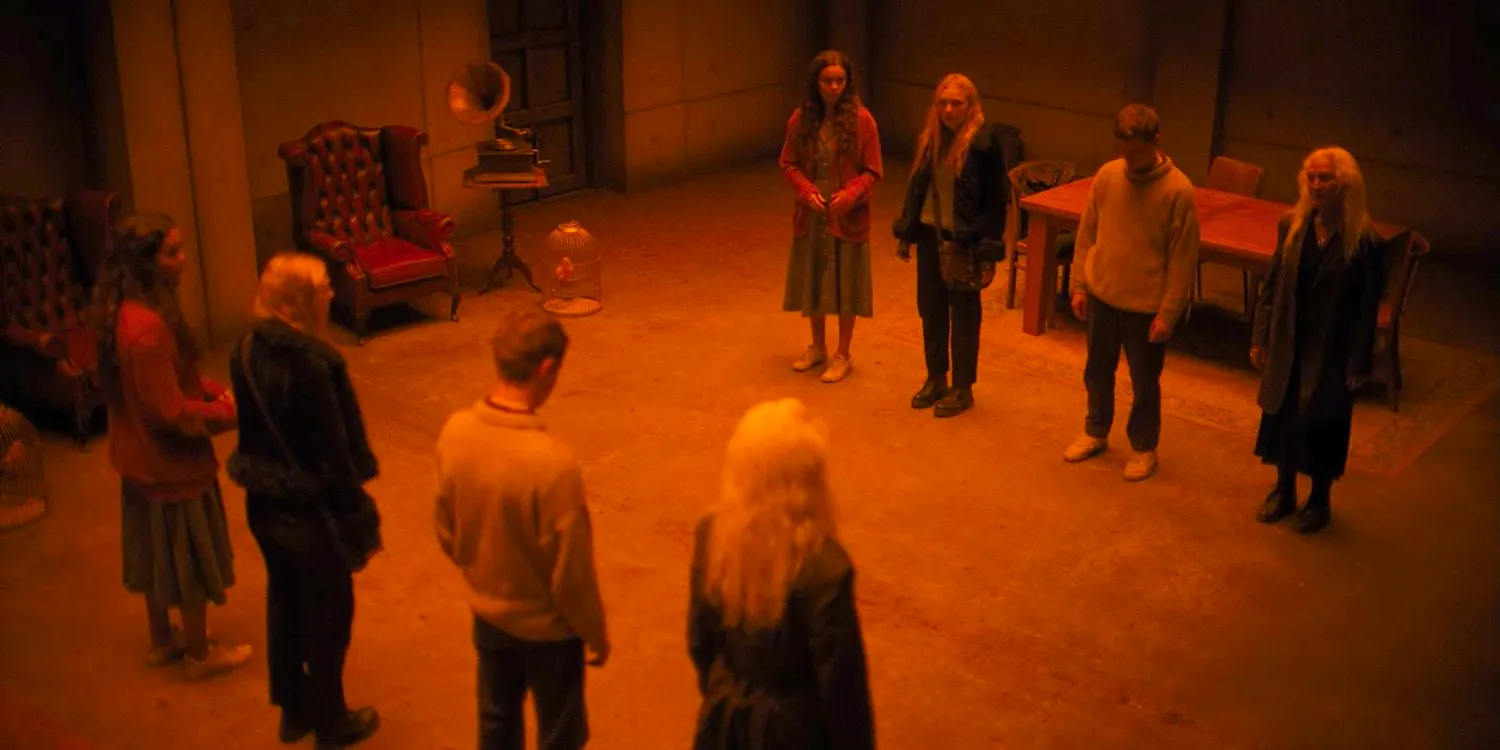 Aerial shot of Madeline, Daniel, Mina, and Ciara standing in front of their reflections in The Watchers Image