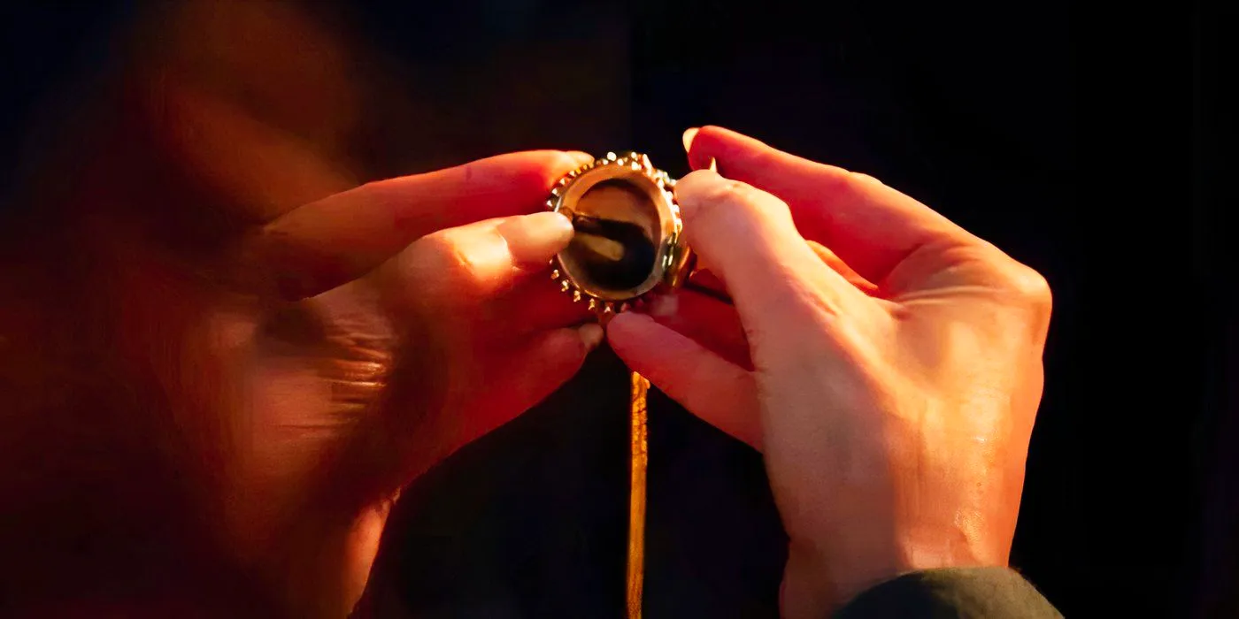 Agatha looking at hair in her locket in Agatha All Along Image