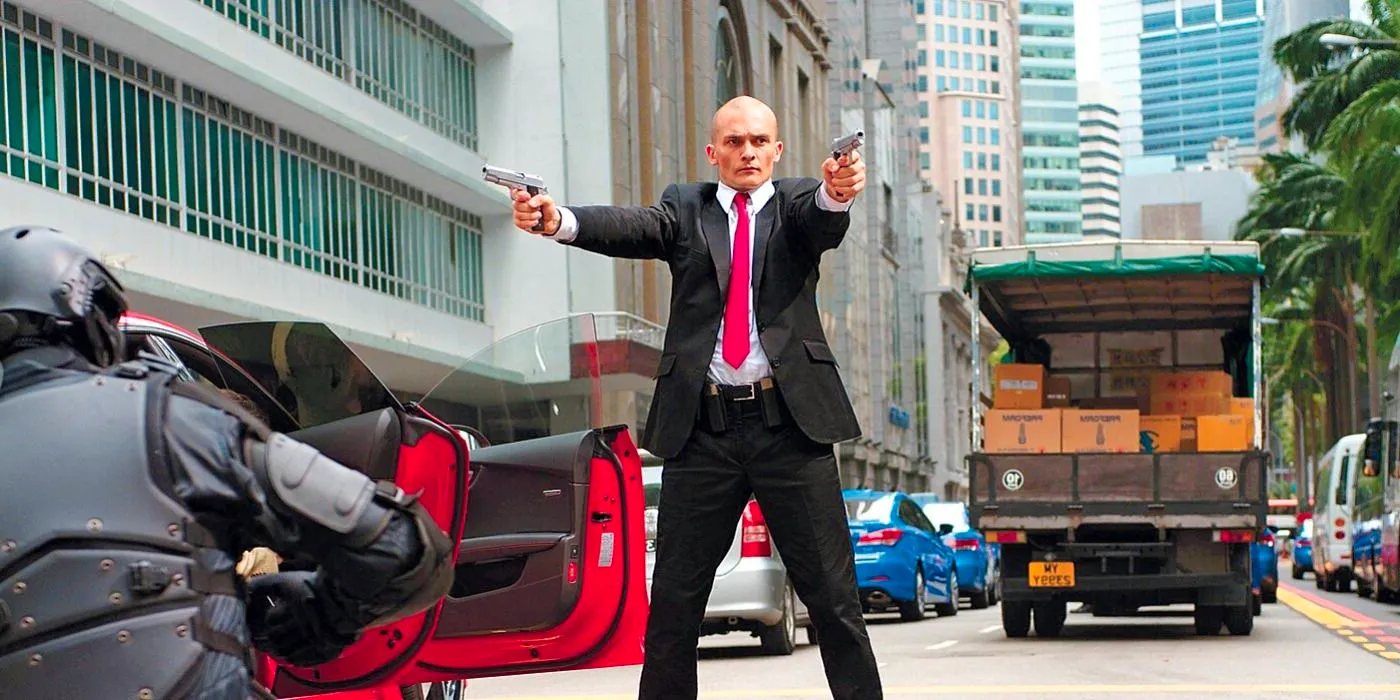 Agent 47 shooting people in the middle of the street in Hitman Agent 47 Image