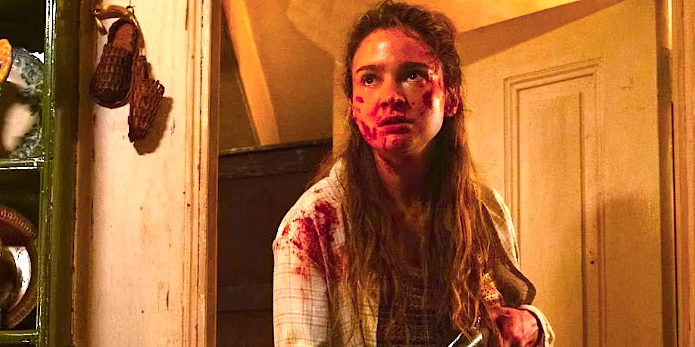 Aisling Franciosi's Ciara covered in blood and holding a gun in a doorway from Speak No Evil 2024 Image