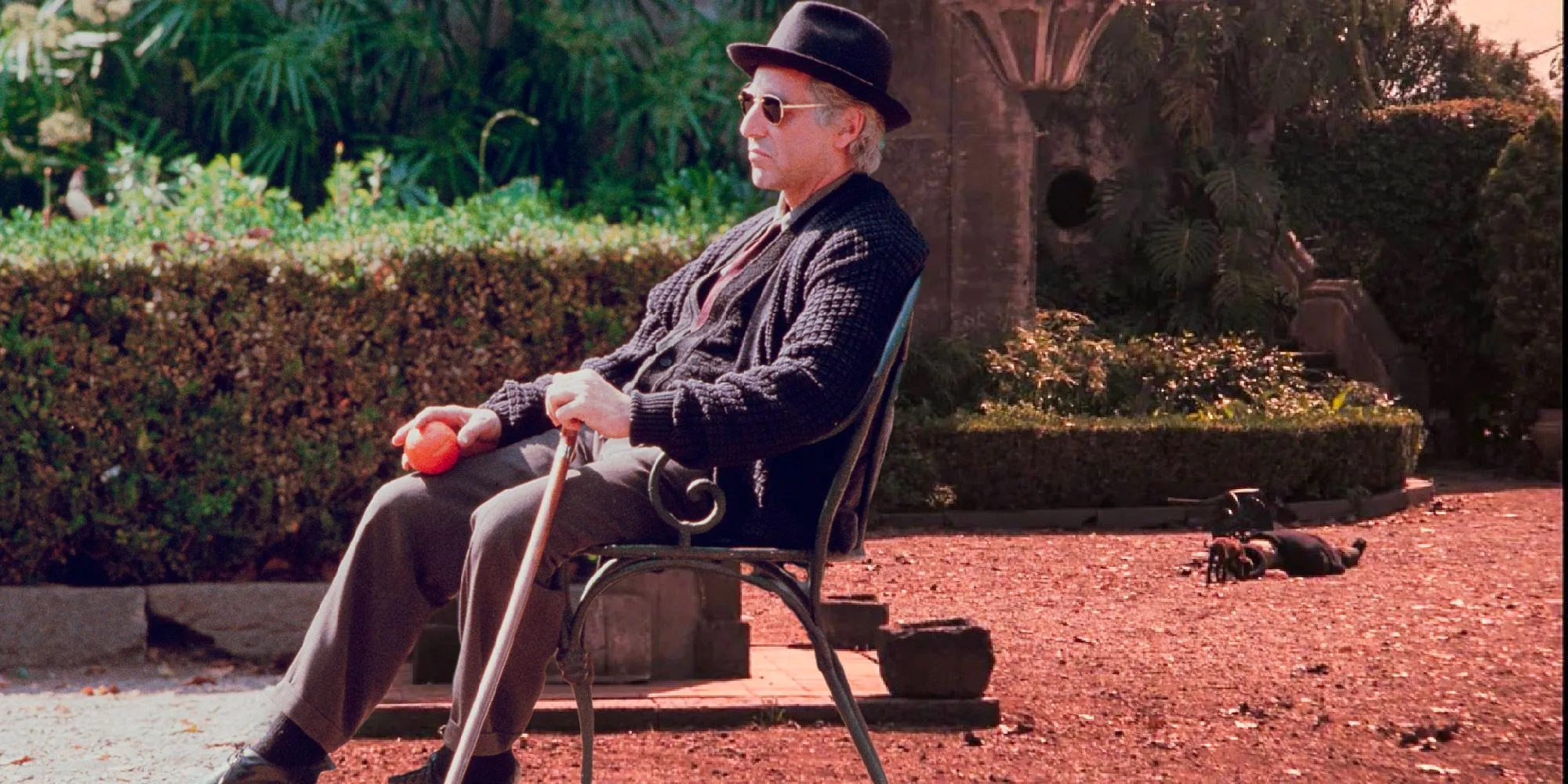 Al Pacino as Michael Corleone dies while sitting on a chair at the end of The Godfather Part III Coda Cut. Image