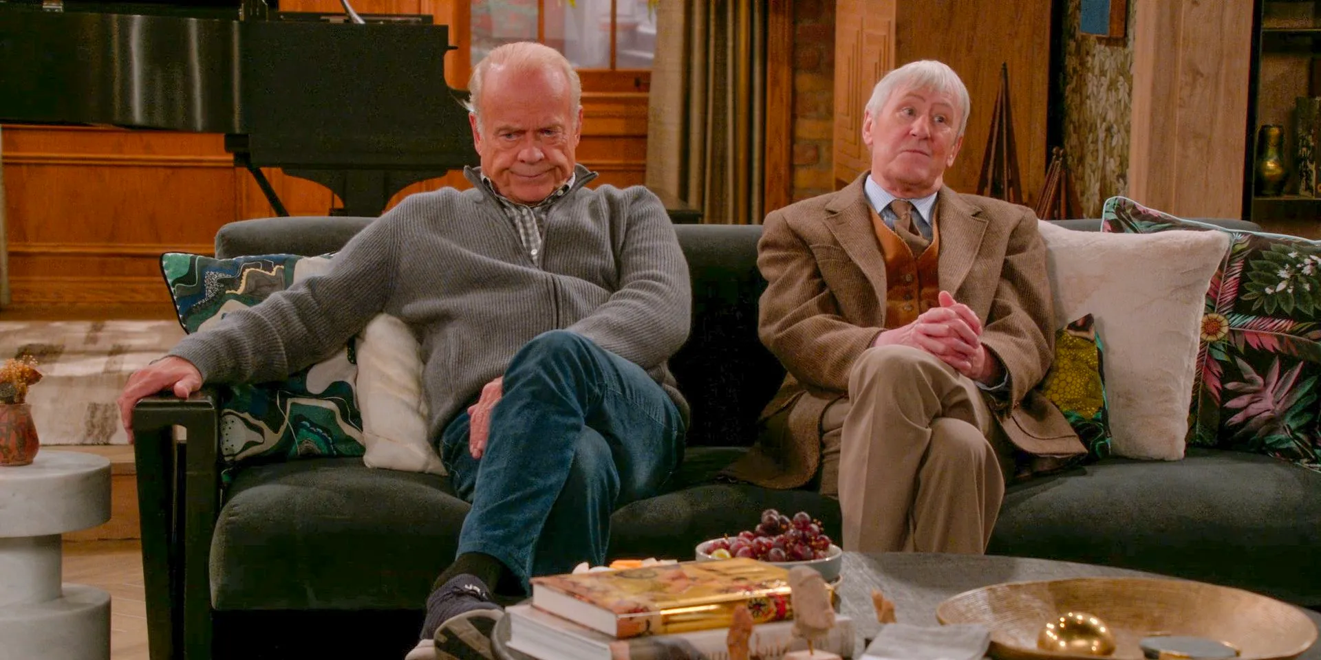 Alan Cornwall (Nicholas Lyndhurst) and Frasier Crane (Kelsey Grammer) sitting next to each other, both looking angry in Frasier (2023) Season 2 Episode 1 Image