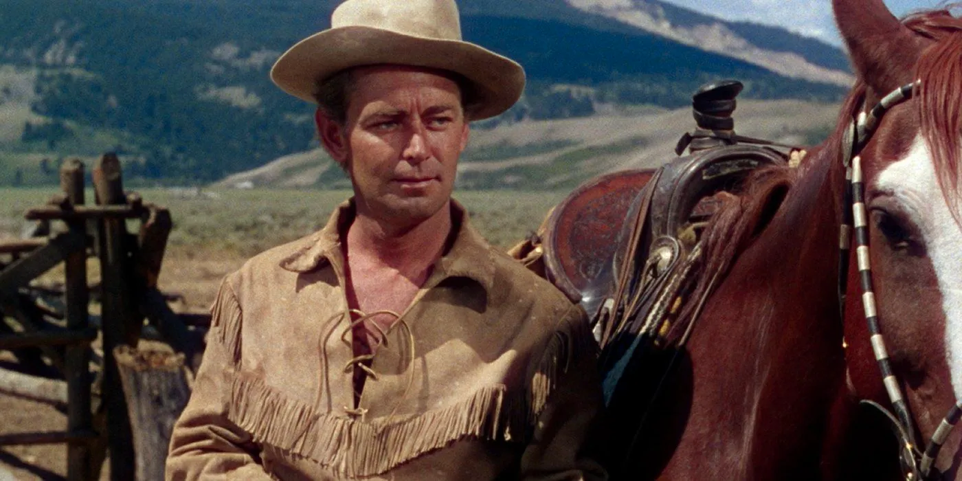 Alan Ladd as Shane stands next to his horse at the Starrett ranch in the ending of Shane Image