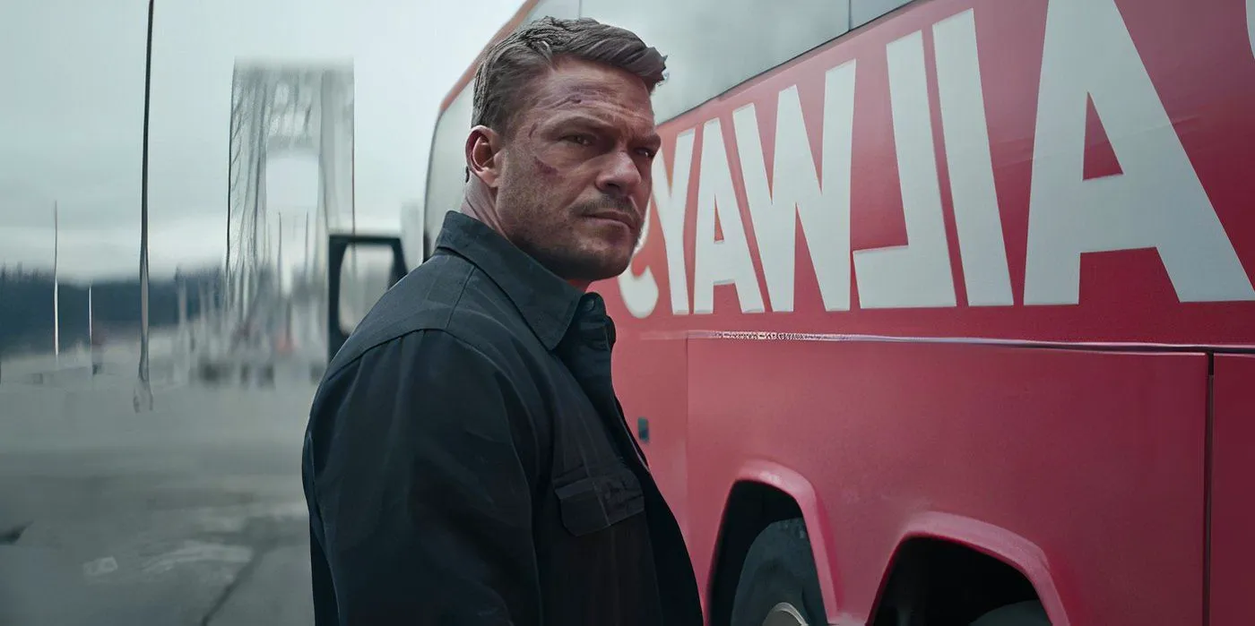 Alan Ritchson as Reacher standing by a bus talking to Neagley. Image