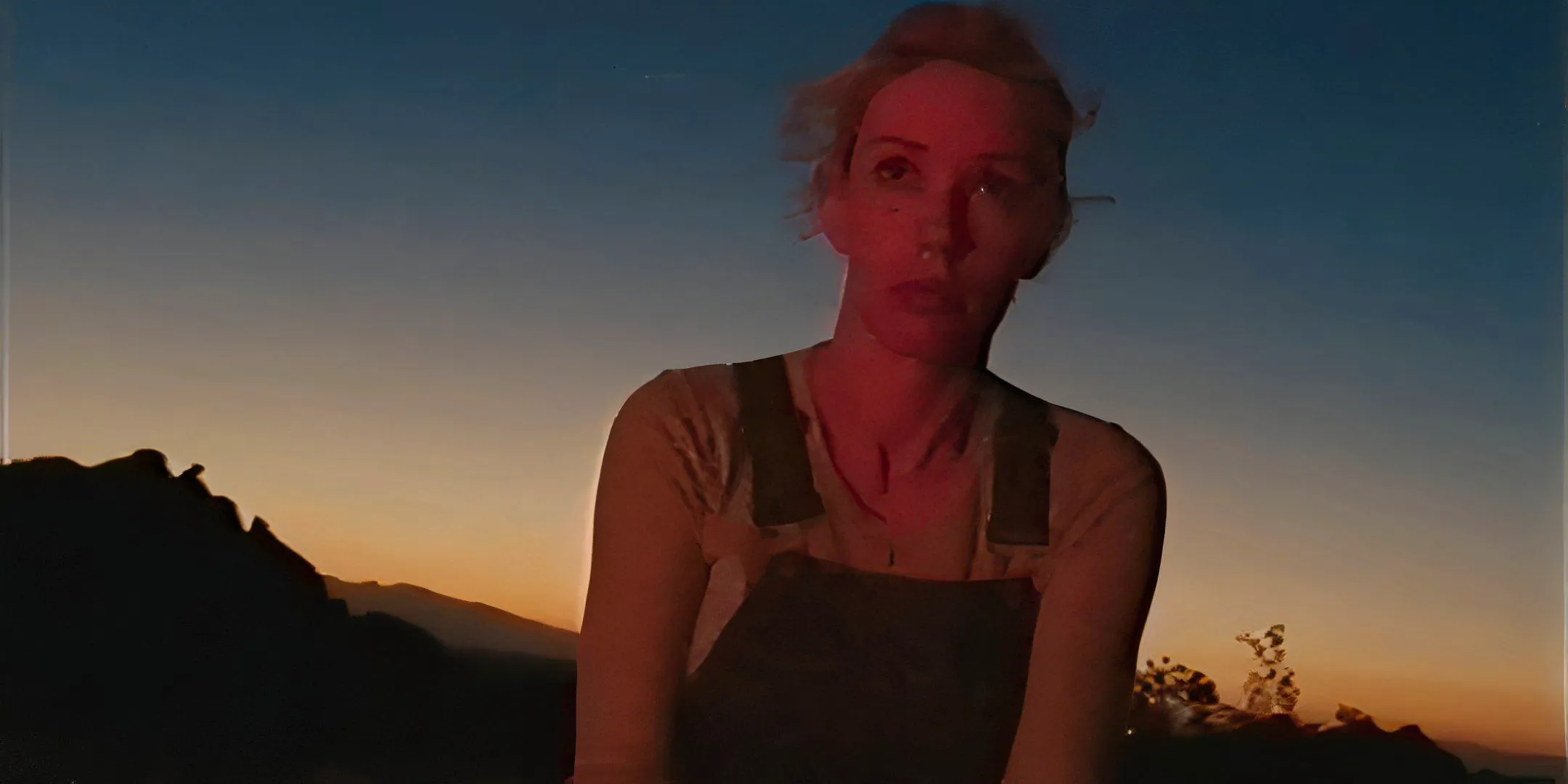 Alanah Pearce as Halley looking dejected off in the distance in V/H/S/Beyond Image