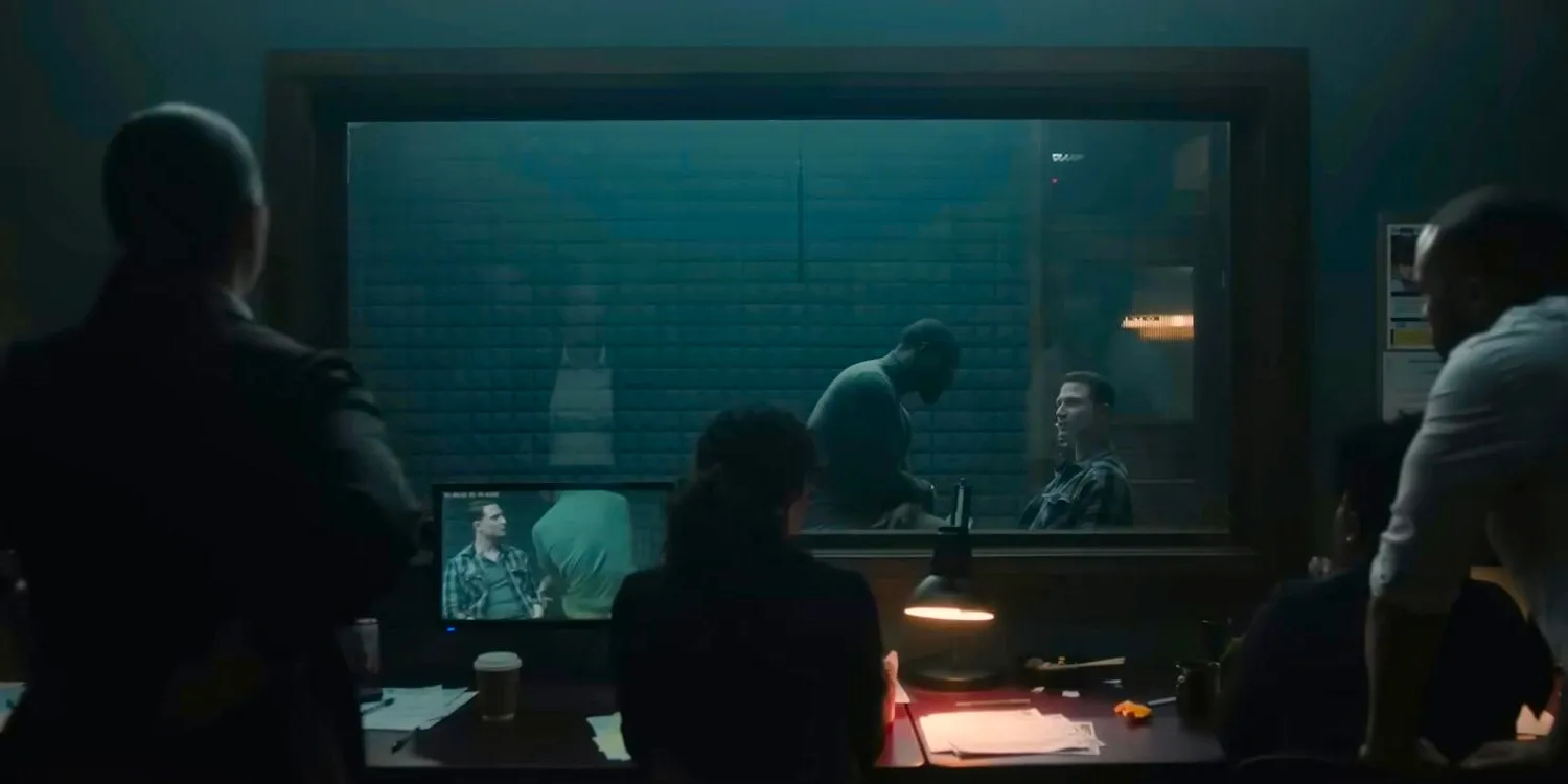 Alex Cross (Aldis Hodge) questioning a man in an interrogation room in Cross Image