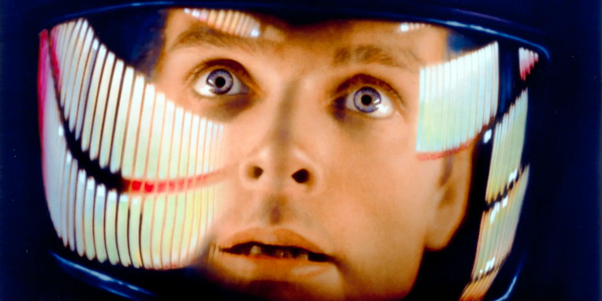 an extreme close-up of Bowman with his space helmet on in 2001: A Space Odyssey Image