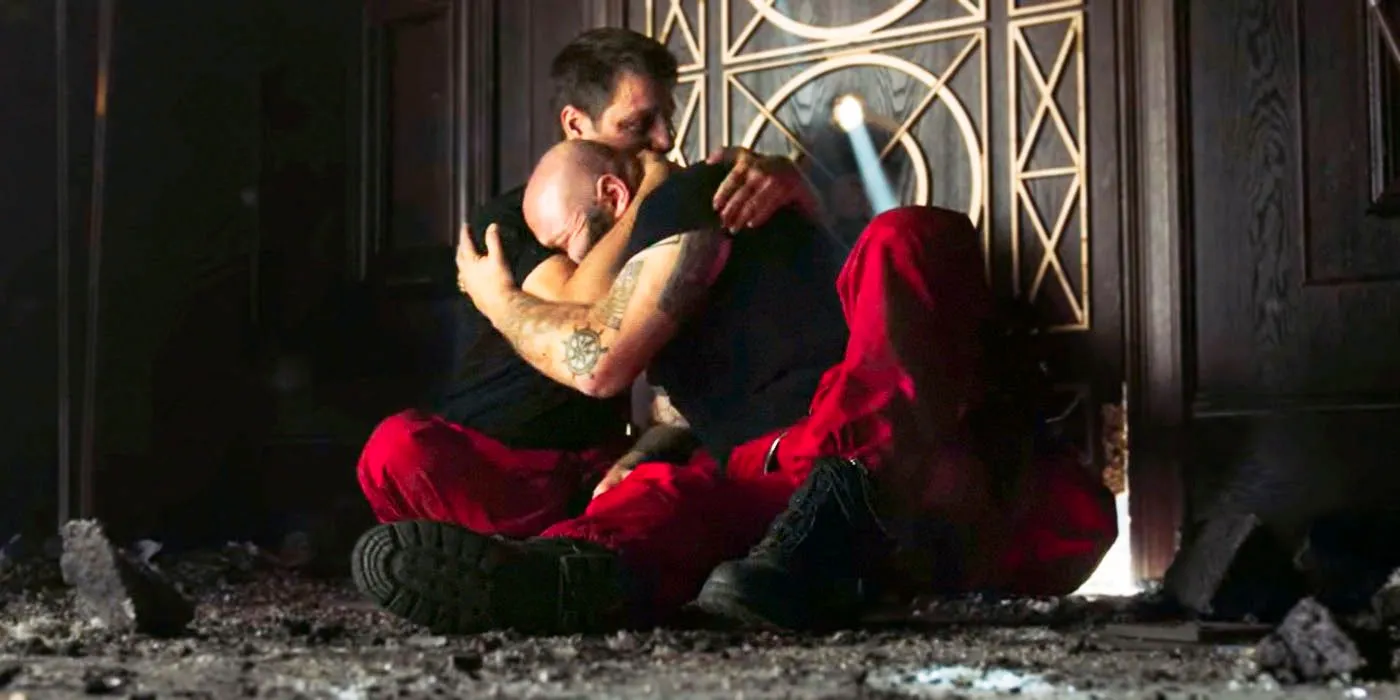 An image of Helsinki and Palermo hugging as they both cry in front of a door in the show Money Heist. Image