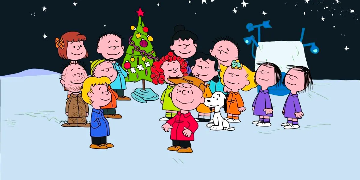 An image of the Peanuts gang around the tree in the Christmas Special is shown. Image