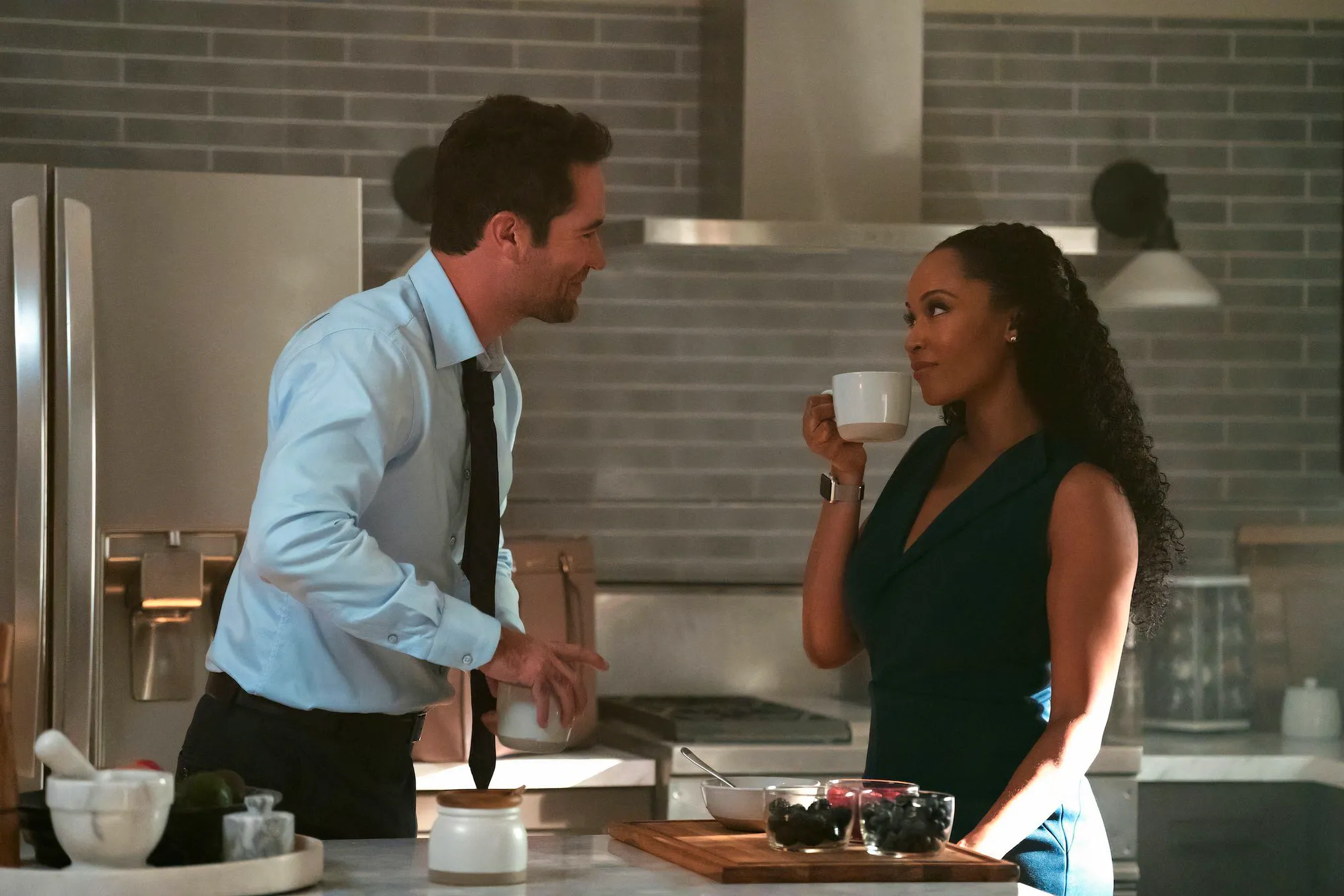 Andrea and Mickey in a kitchen scene from Lincoln Lawyer season 3 Image