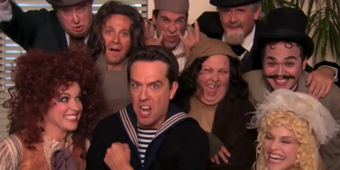 Andy and the cast of his play huddled together in front of the camera in The Office Image