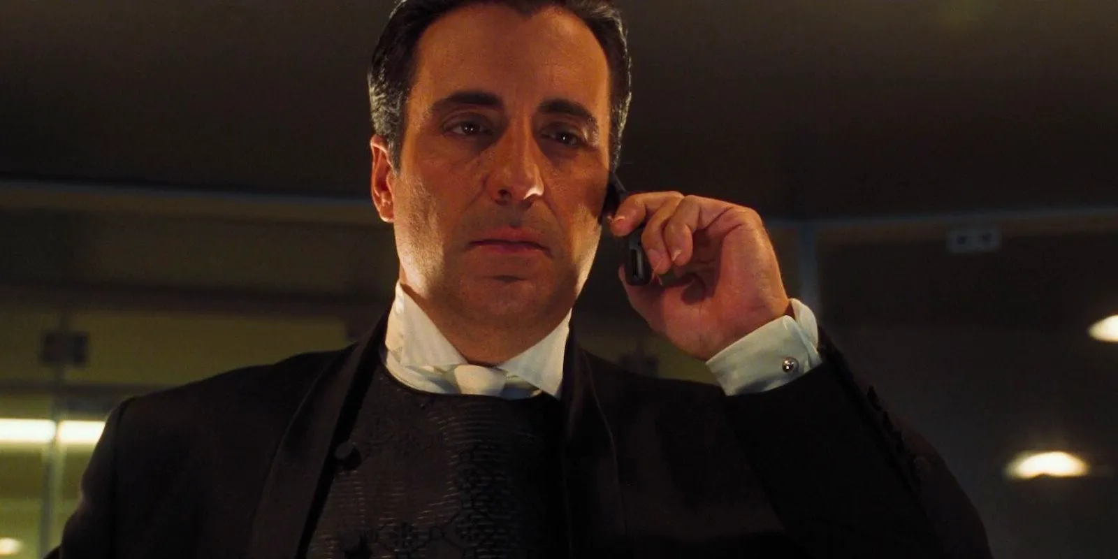 Andy Garcia as Terry Benedict talks on a cell phone in Ocean's Eleven Image