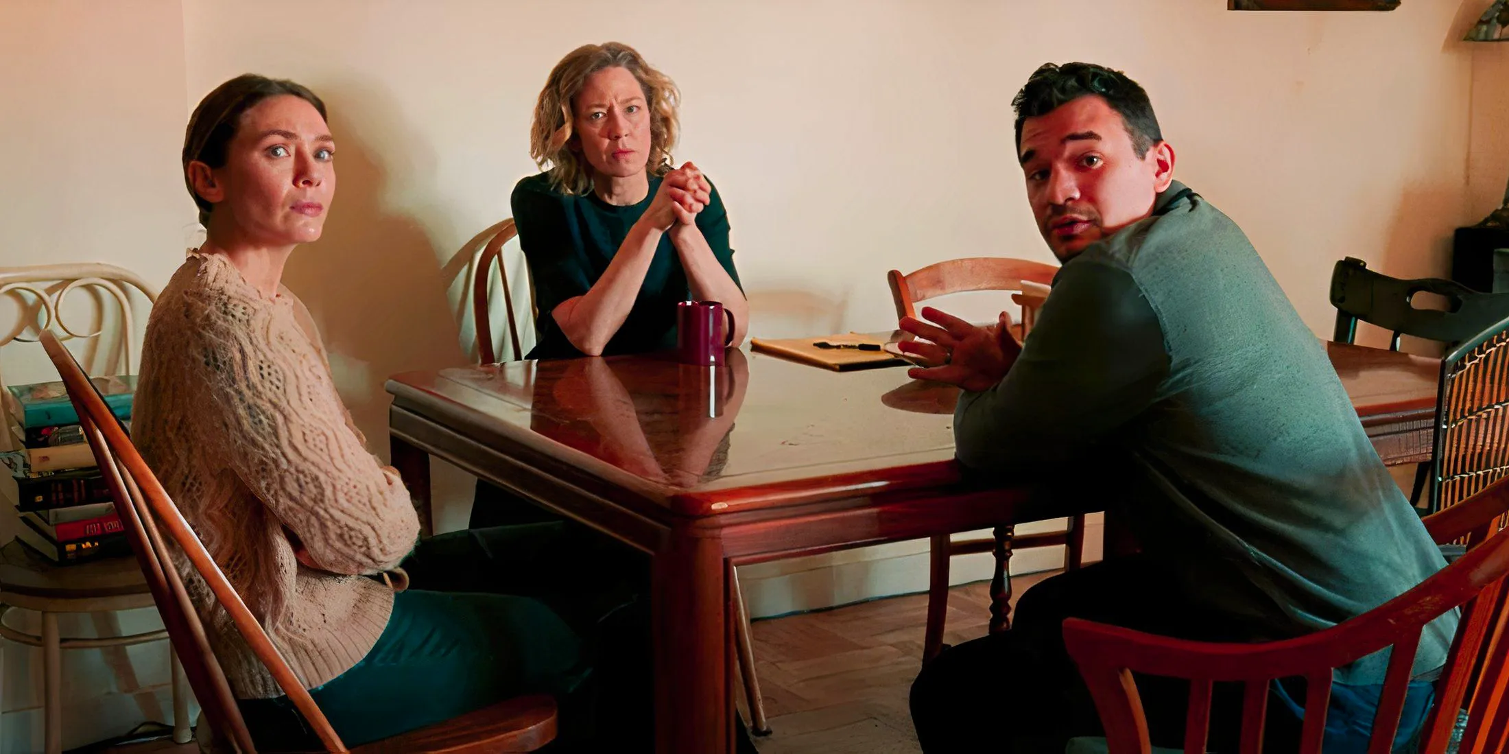 Angel, Katie, and Christina sitting at a table in His Three Daughters Image