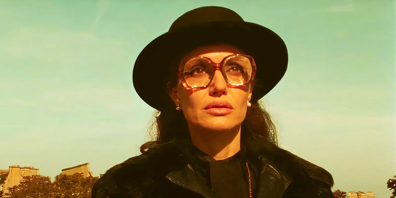 Angelina Jolie wearing a hat and glasses as Maria Callas in Maria Image