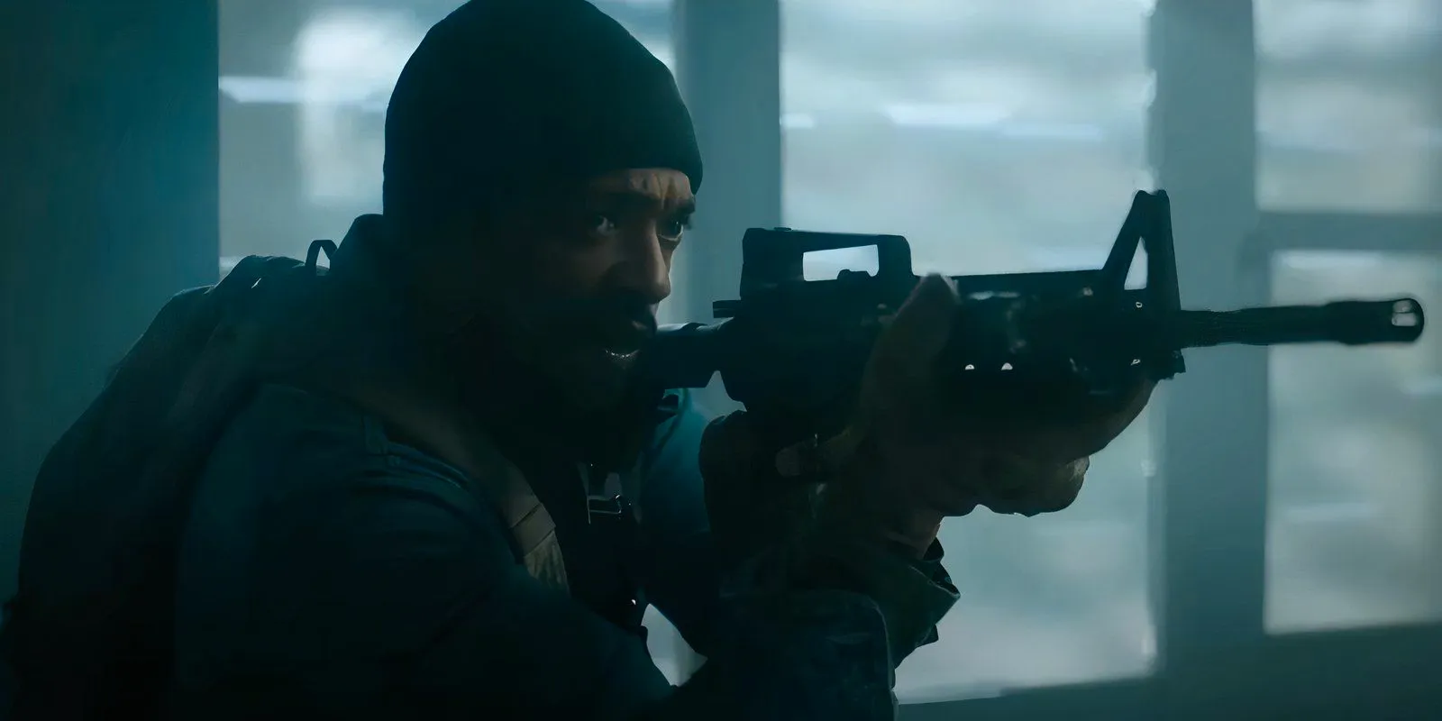 Anthony Mackie holding a rifle in Elevation Image