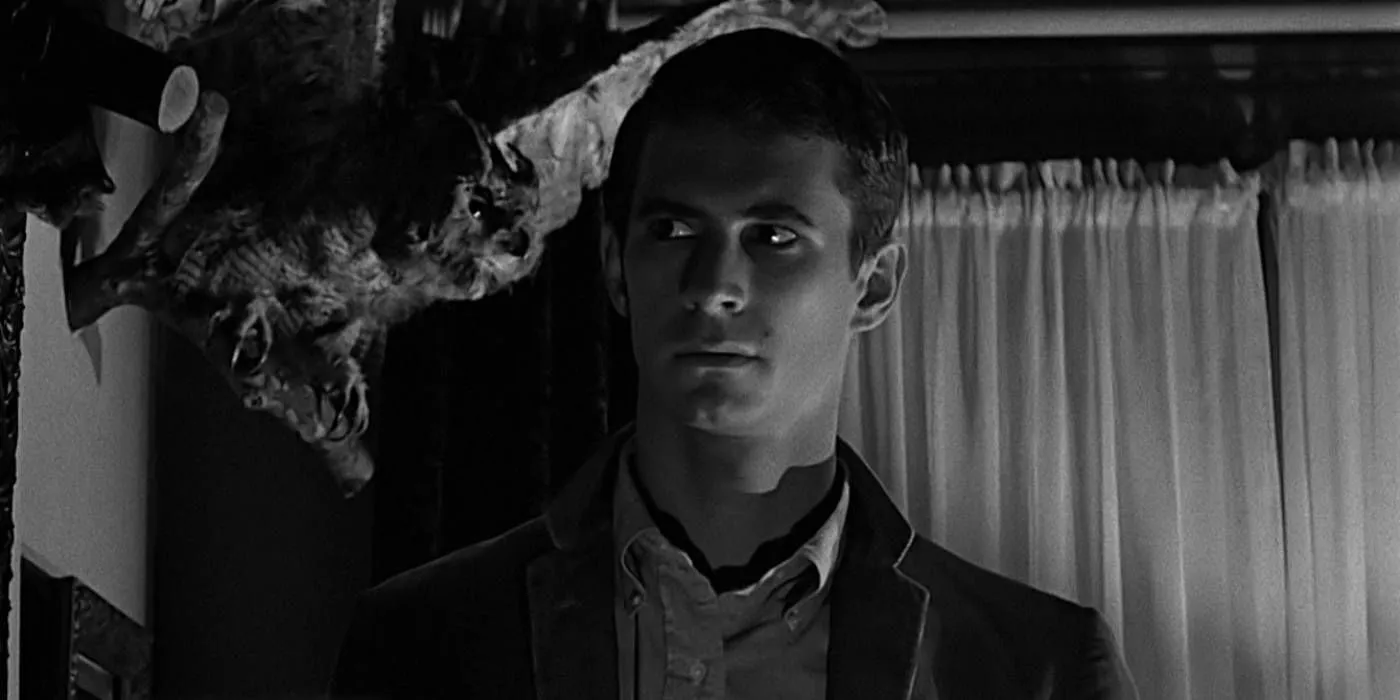 Anthony Perkins as Norman Bates in Psycho in front of an owl in his office Image