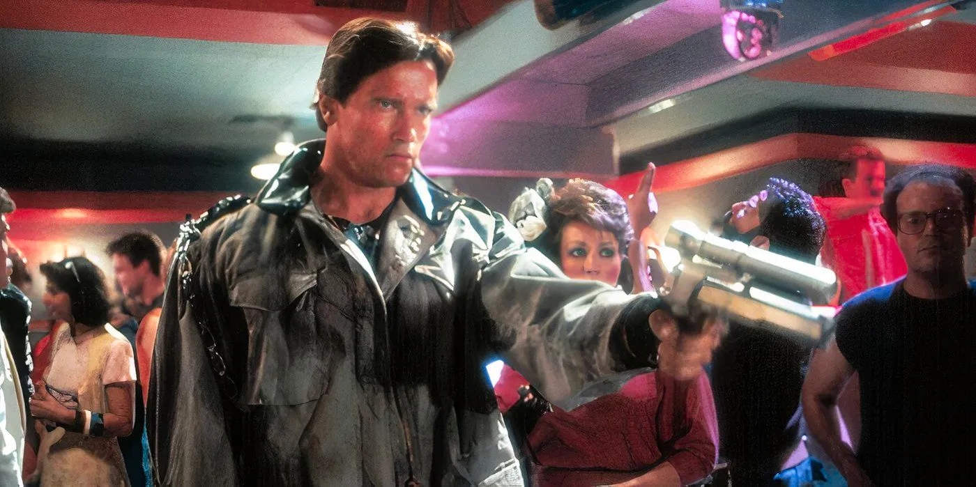 Arnold Schwarzenegger points a gun in the movie The Terminator.  Image