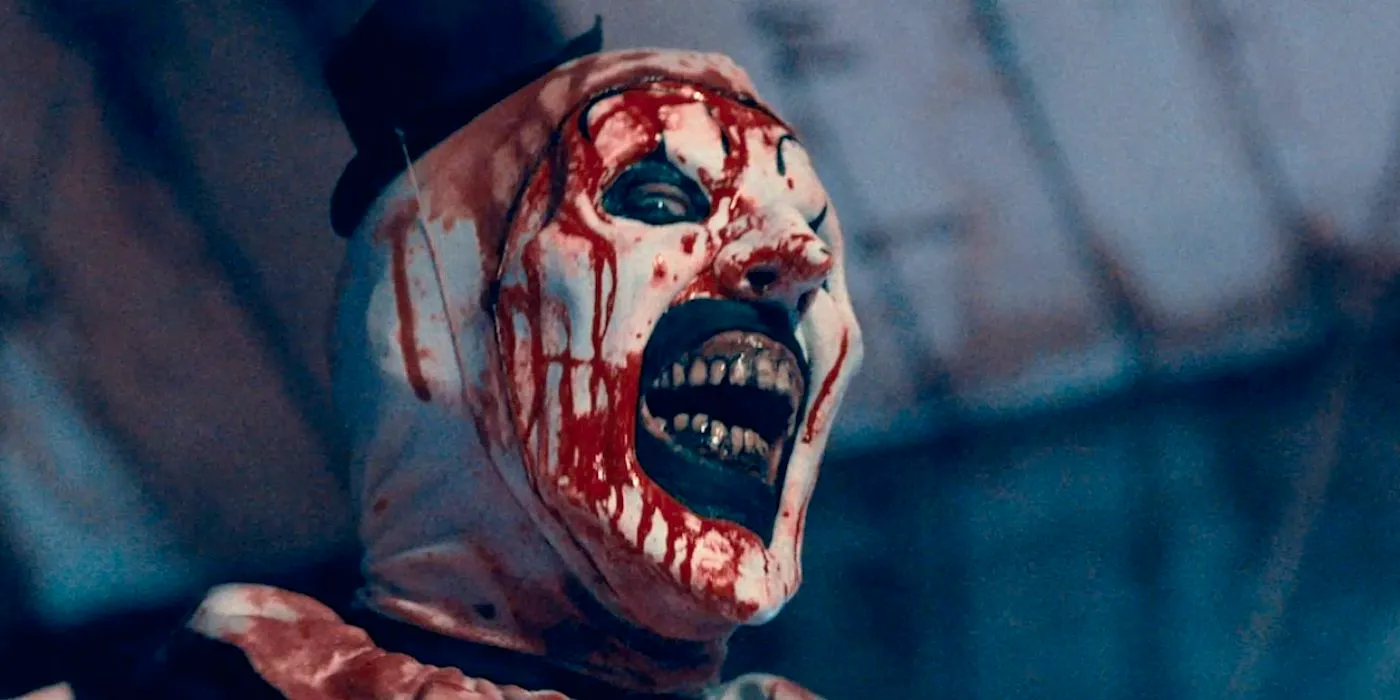 Art the Clown smiling with a bloody face in Terrifier 2 Image