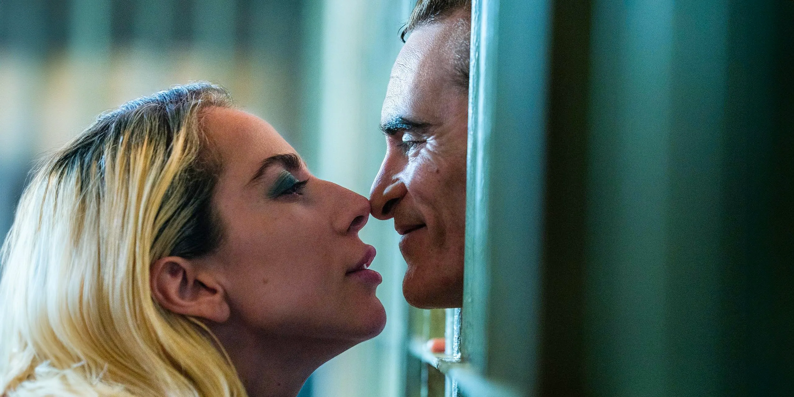 Arthur Fleck/Joker (Joaquin Phoenix) and Lee Quinzel/Harley Quinn (Lady Gaga) share a nose-to-nose kiss in Joker: Folie à Deux Image