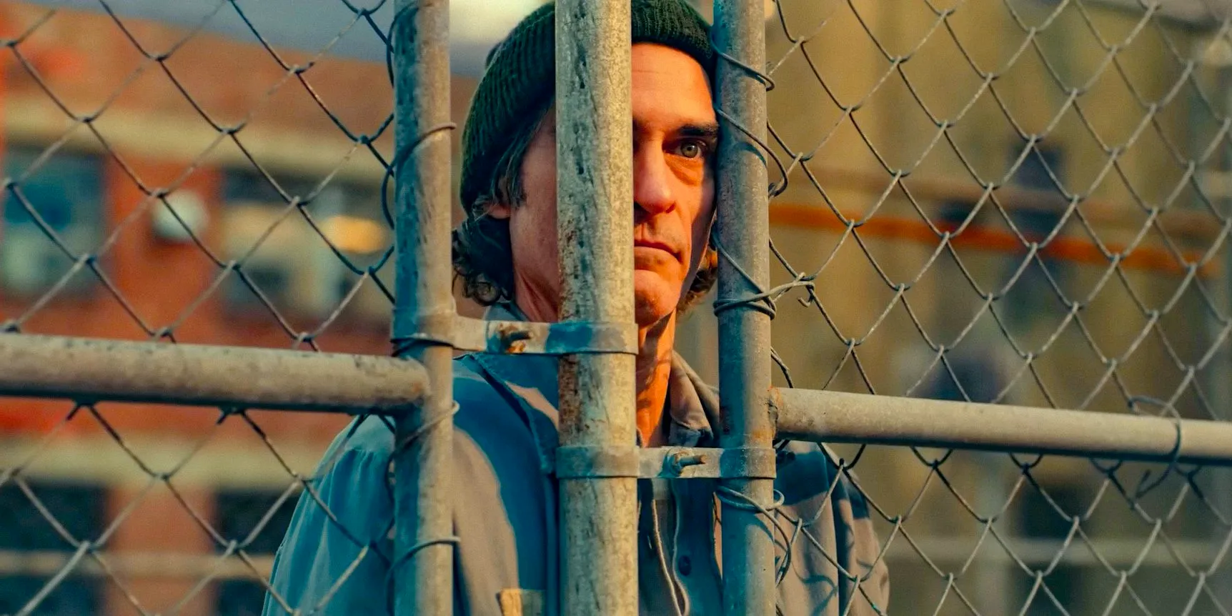 Arthur Fleck/Joker (Joaquin Phoenix) contemplative behind bars in Joker: Folie à Deux Image