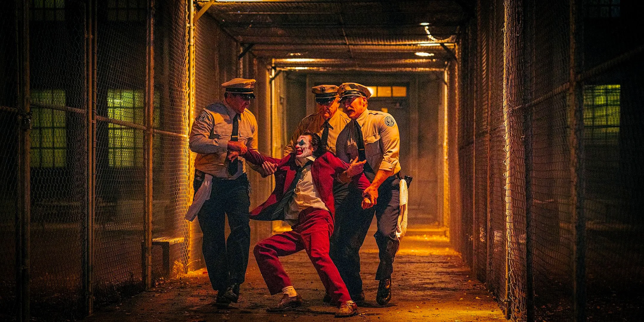 Arthur Fleck/Joker (Joaquin Phoenix) struggling with police officers in Joker: Folie à Deux Image