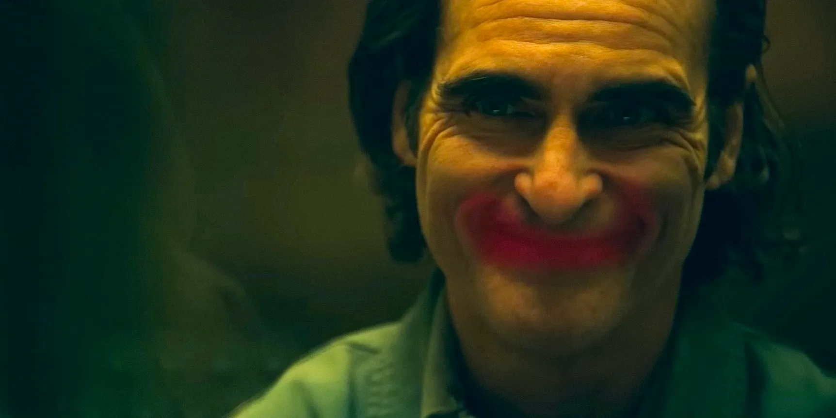 Arthur Fleck/Joker (Joaquin Phoenix) with a smile painted with red lipstick in Joker: Folie à Deux Image