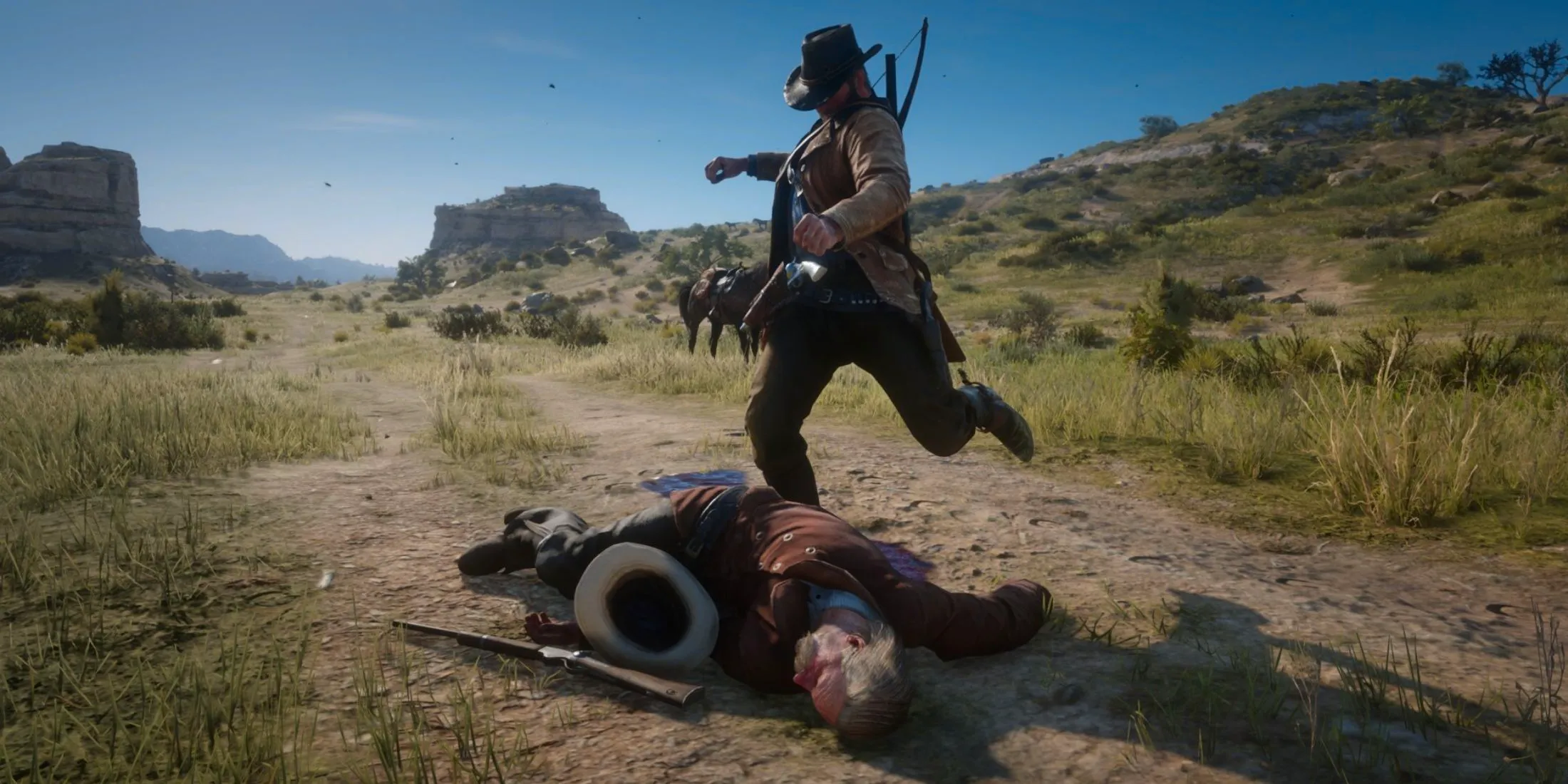 Arthur kicking someone in Red Dead Redemption 2. Image